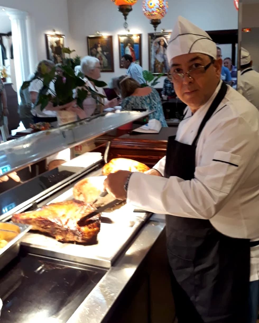 Chef Ahmet carving roast meat at a carvery counter